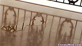 Lesbians in lingerie engage in anal play, enema and pee together