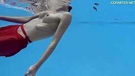 Petite brunette swims in the pool and enjoys sensual pleasures.