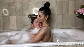 Nelly Kent and Gina Gerson share a steamy lesbian fuck in the bathroom
