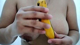 busty filipinas engage in sensual banana boob play while masked for fantasy delight