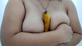 busty filipinas engage in sensual banana boob play while masked for fantasy delight