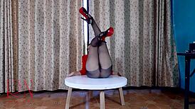 sexy lady strips in pantyhose and heels on round table