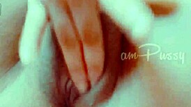 She fingers her shaved pussy closeup