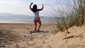 Filming a curvy European babe doing exercises and changing on the public beach
