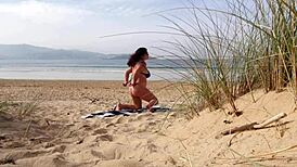 Filming a curvy European babe doing exercises and changing on the public beach