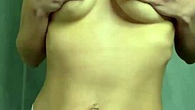 a student caresses her natural breasts at home