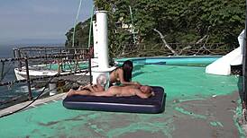 Young couple enjoys outdoor activities on the beach with kissing and natural scenery.