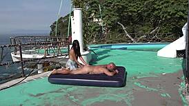 Young couple enjoys outdoor activities on the beach with kissing and natural scenery.