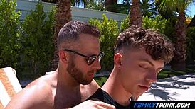 Familytwink stepdad basks in the sun, getting spicy rimjob action by the pool.