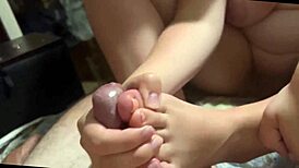 Young Babe Delivers Sensual Footjob with Closeup Cumshot Action.