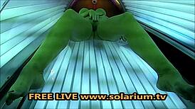 horny milf with big breasts masturbates in solarium.