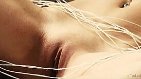 delphine fingers her shaved pussy solo on the sofa