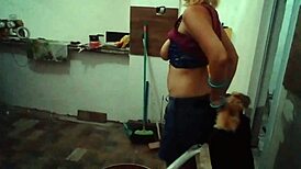 Blonde milf cook Stella Still shows off her big tits in the kitchen wearing red.