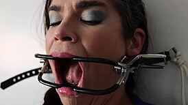 Extreme gag predicament with mother-in-law nailed to wall in nylon fetish setup