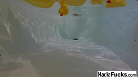 Sexy nadia bathes with rubber duckies