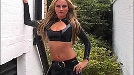 Blonde latex babe Amanda struts outdoor in tight rubber boots