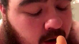 The young gay chub eagerly sucks the dildo before riding it passionately.