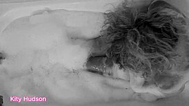 Kitty Hudson enjoys a relaxing bath with a toy