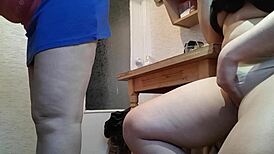 Amateur masturbates in kitchen next to stepmother, risking orgasm