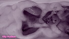 Kitty Hudson enjoys a relaxing bath with a toy