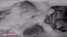 Kitty Hudson enjoys a relaxing bath with a toy