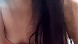 Amateur video with a young woman in an intimate setting.