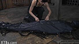 Hey, what’s this restrained girl getting punished for in the garage?