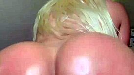 Blonde with huge oiled tits twerks her massive buttocks.