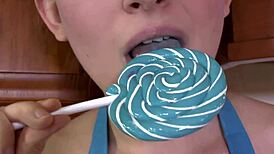 Beautiful Brunette Sucks On A Lollipop In High Heels