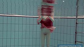 Katya Okuneva looks stunning in her red dress by the pool.