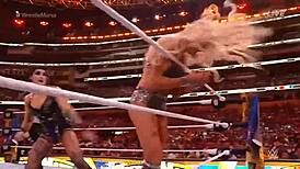 rhea ripley battles charlotte flair in a intense wrestling match at wrestlemania