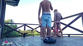 Leaked video of students recording orgy on dorm deck in red and sheer outfits.