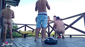 Leaked video of students recording orgy on dorm deck in red and sheer outfits.