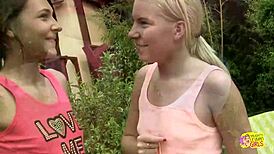 Adorable blonde and brunette girls rip clothes, masturbate, finger, kiss, and eat pussy outdoors