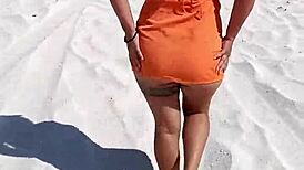 Wow, check out this horny Mexican slut flashing her thong and natural tits right on a public beach!