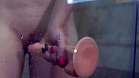 babe casually sucks dildo and fucks her shaved pussy in the shower