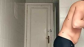 sexy guy shaving in black beach shorts