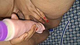 The desi sexy bhabhi grabs her huge dildo and fucks her hairy pussy hard, moaning loudly as she cums