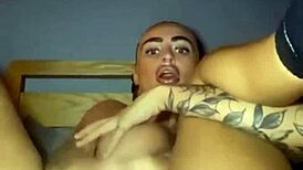 Tattooed goth woman fingers herself