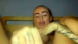 Tattooed goth woman fingers herself