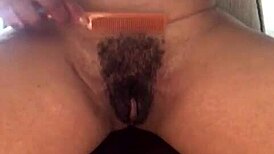Ebony milf shows hairy pussy and big clit in solo close-up
