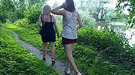 Two girls, a milf and a lady, stop by the road to indulge in golden rain.