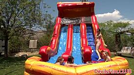 Lesbian Beauties Toying Each Other's Pussies with Dildos Outdoors