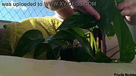 Naked Woman Waters Plants on Balcony for Curious Viewers