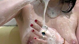 Girl takes relaxing bath with foam