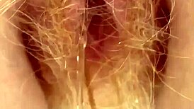 Redhead pees through her hairy pussy in this raw fetish scene.