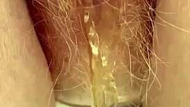 Redhead pees through her hairy pussy in this raw fetish scene.