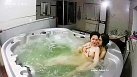 young lesbian couple takes bath and fingering in jacuzzi