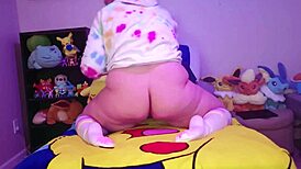 Chubby femboy eagerly stretches ass with massive dildos on bed