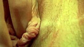 This brunette slut fingers her pussy with a dildo while watching porn